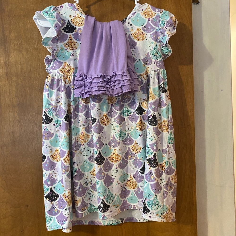 Mermaid tunic and purple ruffle shorts.